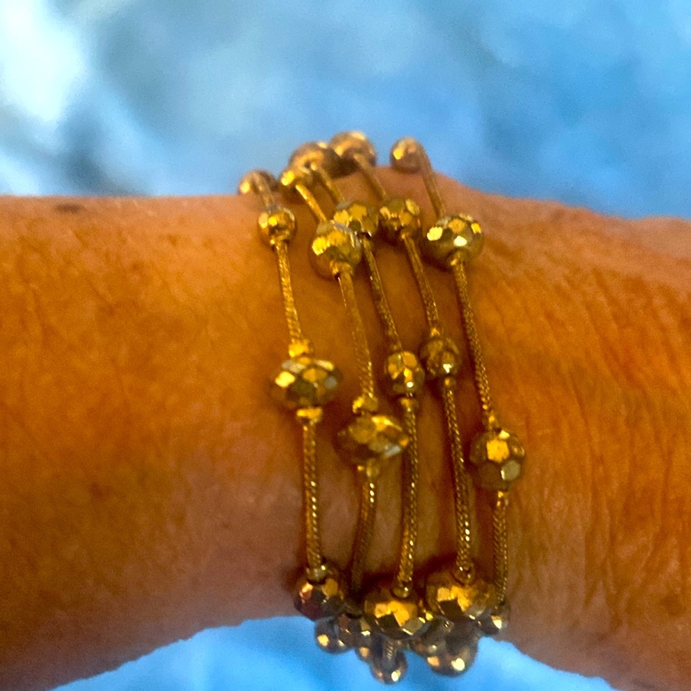 3/$15. Gold tone bracelet with slide closure